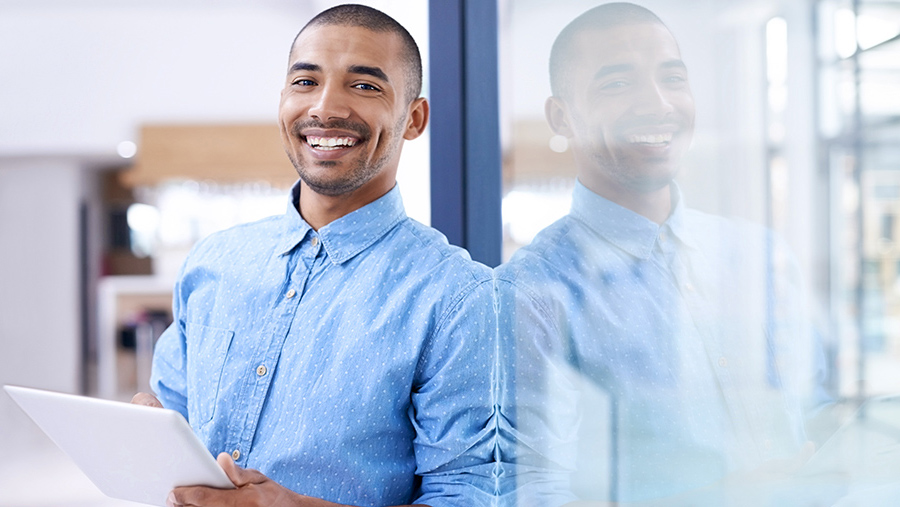 A professional looking man, happy, looking at the camera