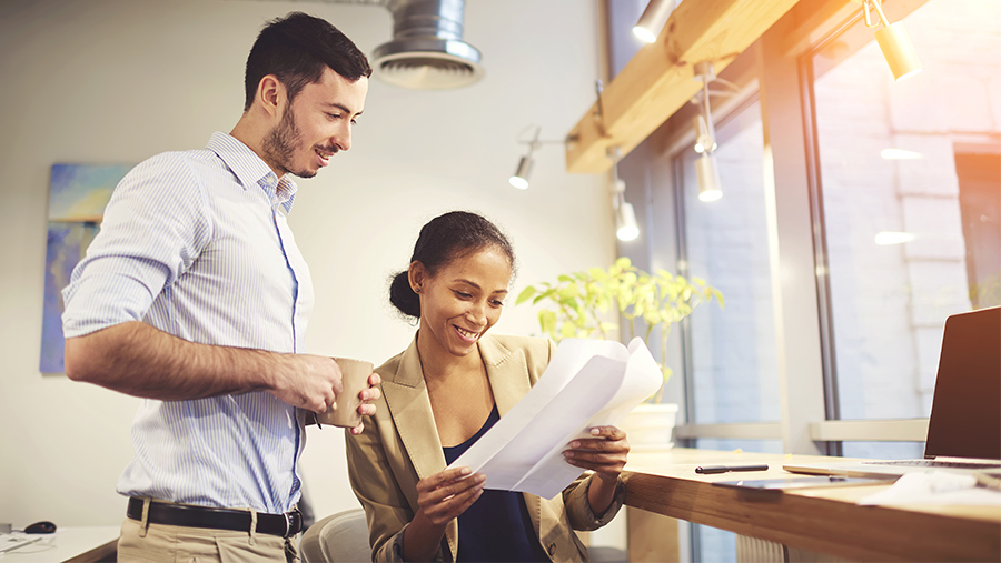 Two coworkers reviewing some documents in an office environment