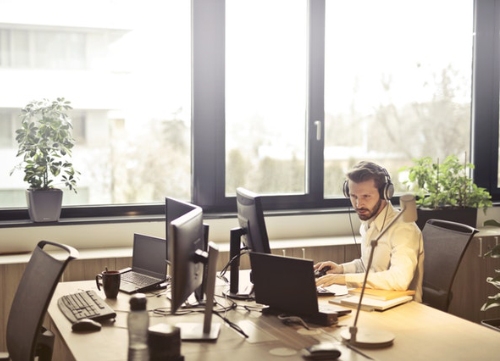 A general shot of a office space, with one worker on his work space